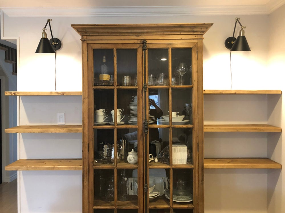 iphone shot of diy floating shelves on the wall empty
