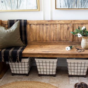 wire baskets under wooden bench in Shannon's home entryway