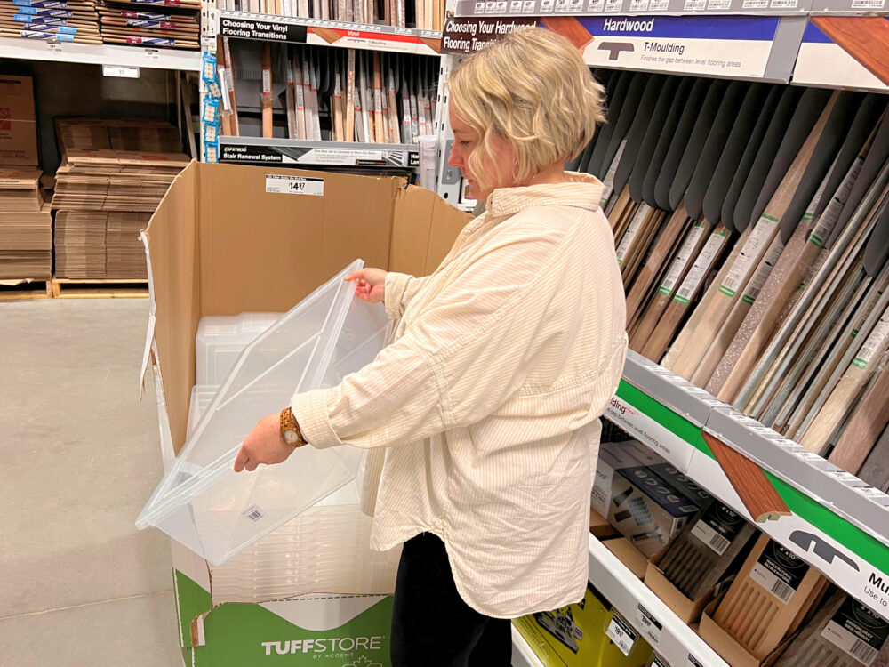 Shannon with clear tote in Home Depot to illustrate why organizing clutter never works
