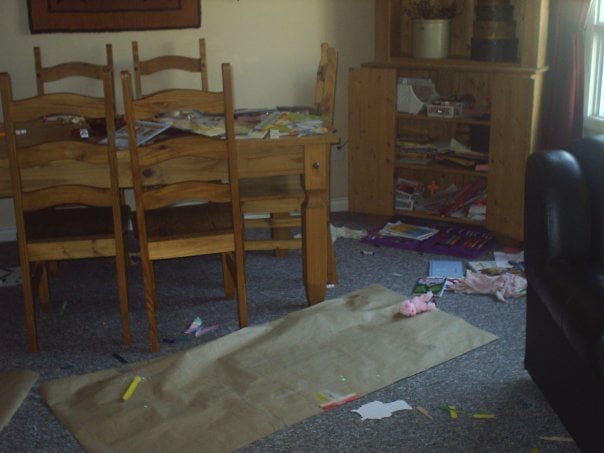 kids stuff all over the floor - butcher paper, art supplies, dolls, etc.