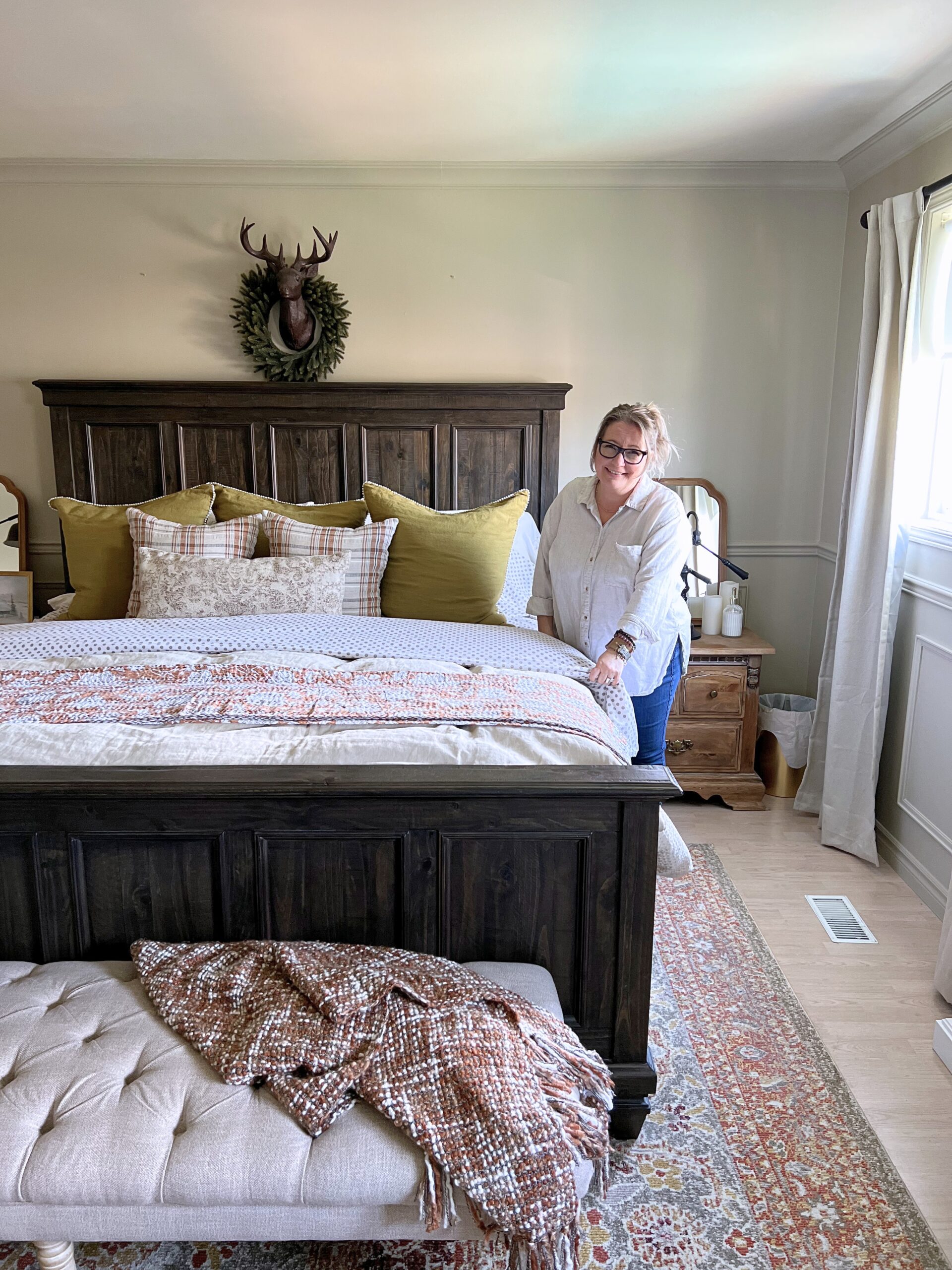 Shannon making bed to illustrate how to find Gratitude for the Home You Already Have