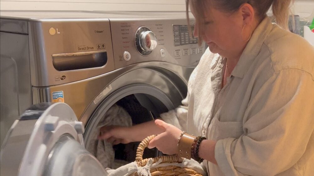 Shannon putting laundry in washer