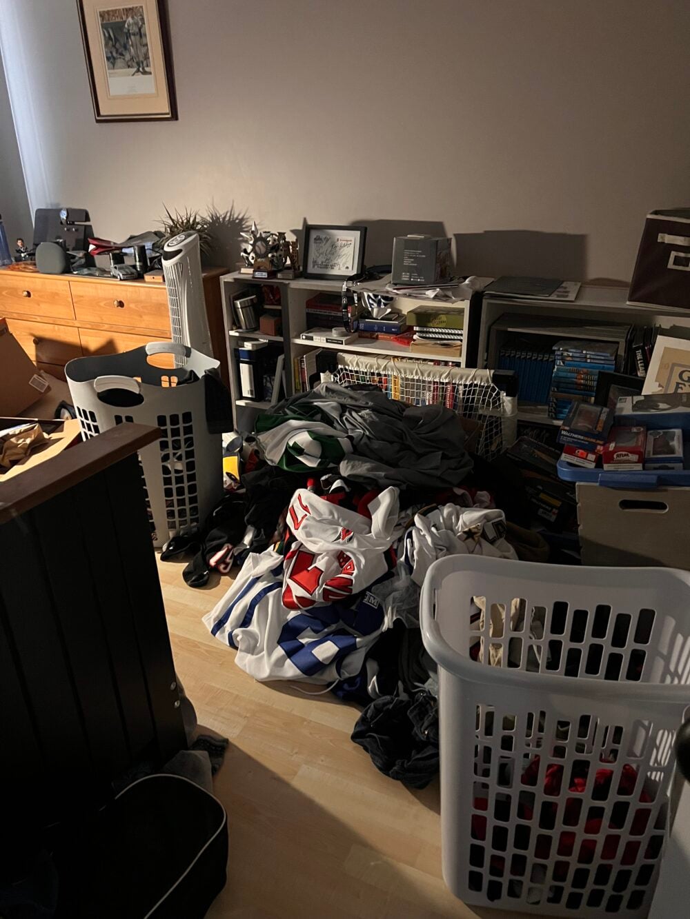 cluttered messy bedroom with piles of clothes on the floor