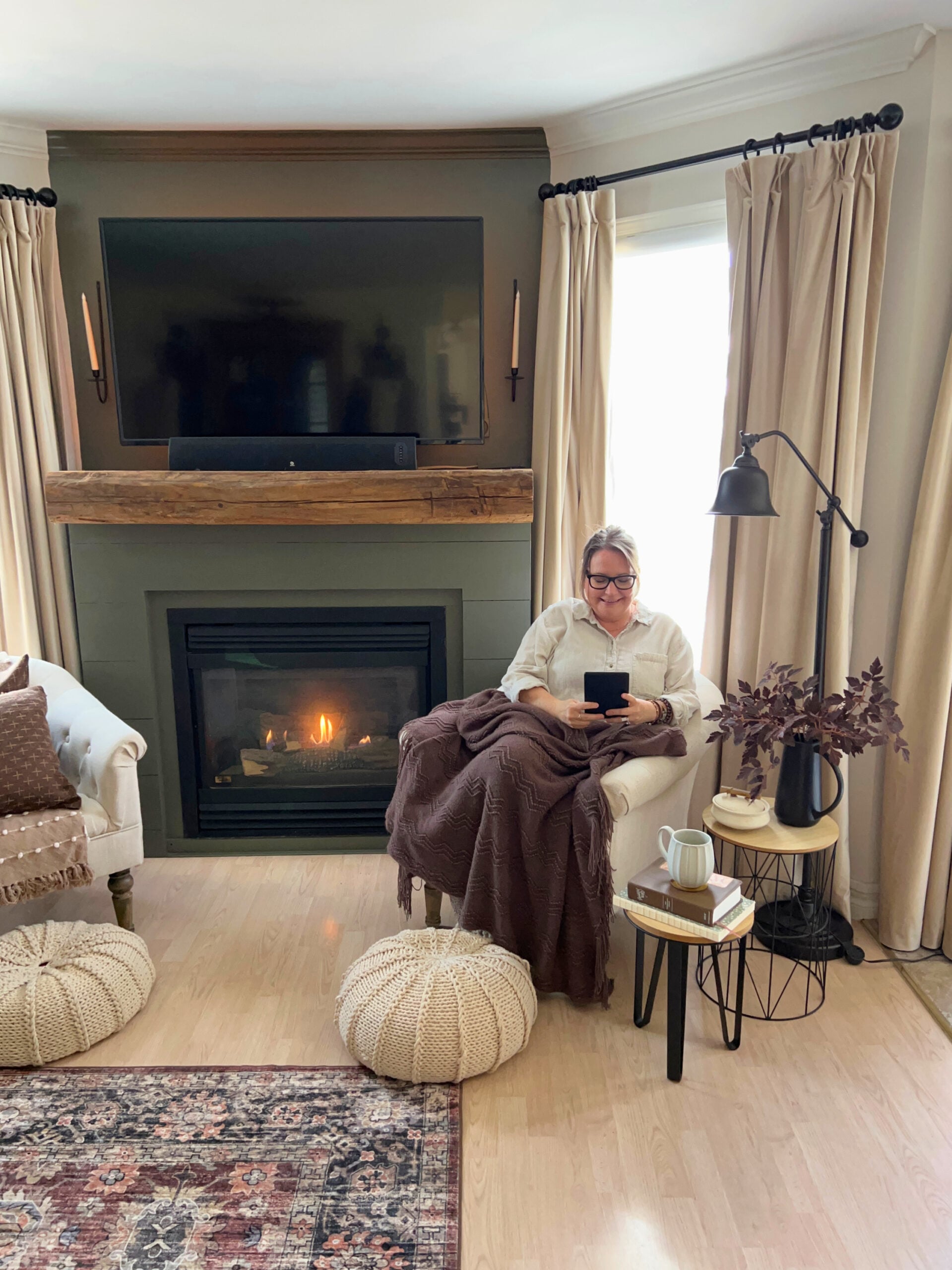 shannon sitting in coffee chair with blanket and kindle pony tail
