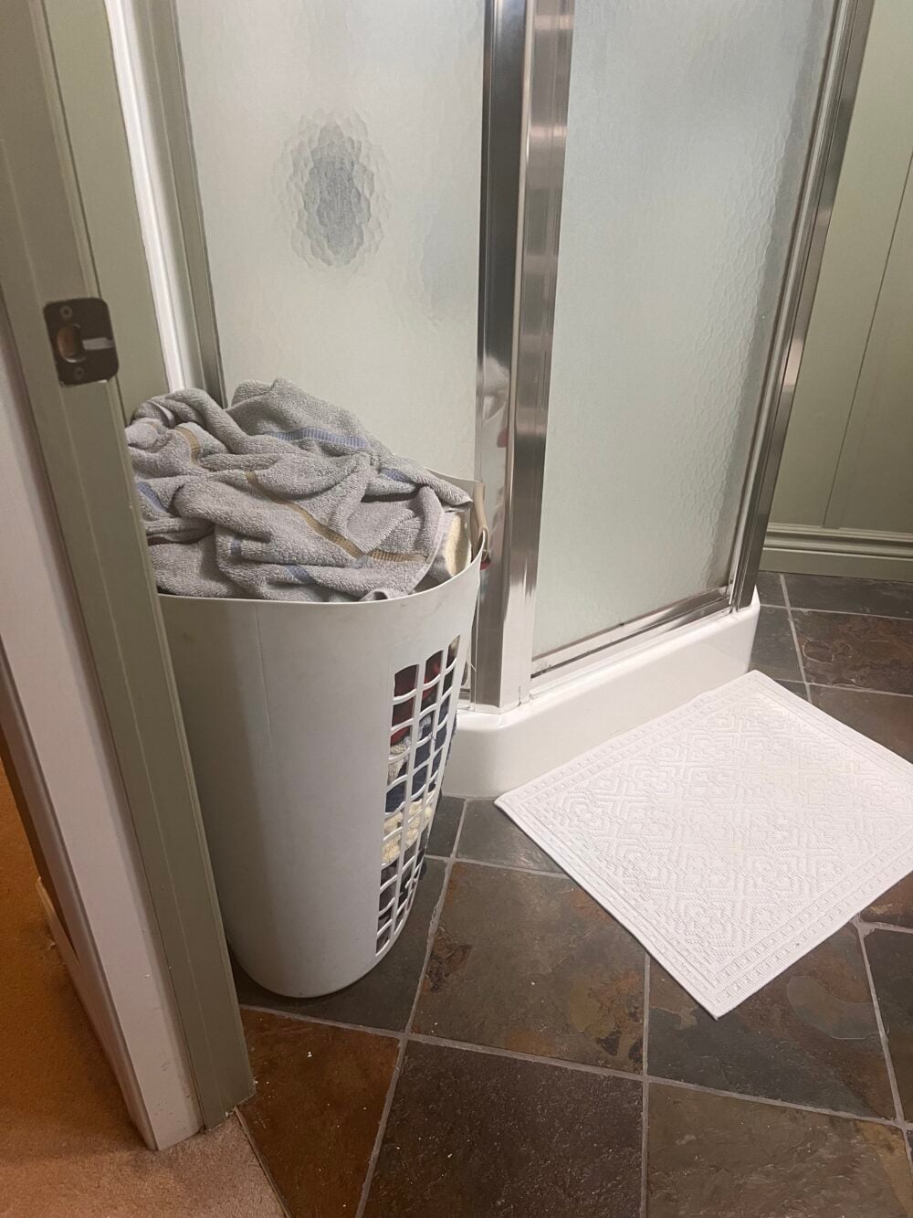 dirty clothes in basket in bathroom